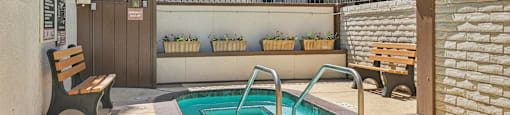 the pool is in the backyard of a house with a hot tub