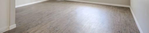 an empty living room with a large window