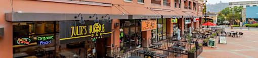 A restaurant named Jules Trumbo is located in a courtyard with tables and chairs.