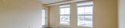 A room with a ceiling fan and carpeted floor.