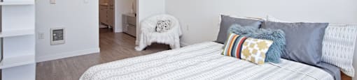 One-Bedroom Apartments In Beaverton, OR - Westline - Spacious Bedroom With Vinyl Hardwood Plank Flooring, High Ceilings, And A Bathroom