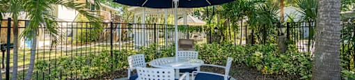 a patio with a table and chairs and an umbrella