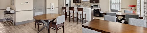 A modern kitchen with a dining table and chairs.