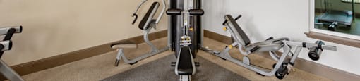 A gym with a variety of equipment including a leg press machine.