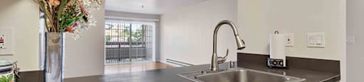 a kitchen with a sink and a vase of flowers