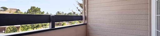 Two-Bedroom Apartments in Daly City, CA - Serra Commons - Patio with Sliding Door, Concrete Floor, and Neighborhood Views