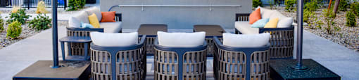 A modern outdoor entertainment area with a television and seating.