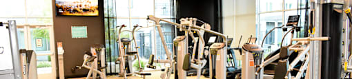 A gym with a variety of exercise equipment.