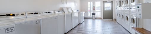 On-site laundry facilities at Sono Tempe Apartments in Tempe, AZ with multiple washers and dryers for resident convenience.