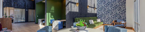 a communal area with a round table with blue chairs and a green couch in the background