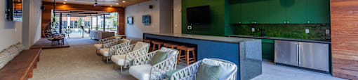 Studios in Old East Dallas, TX - 4600 Ross - Lounge with a Community Kitchen, Various Cozy Seating Options, and Multiple TVs