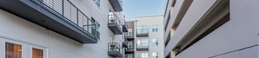 a grassy area on the balcony of an apartment building