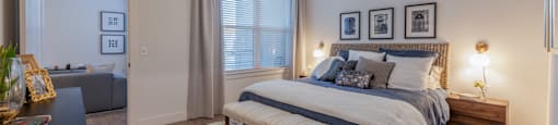 Studio Apartments in Downtown Dallas, TX- 4600 Ross- Bedroom with Wood-Style Flooring, a Ceiling Fan, and a Large Window