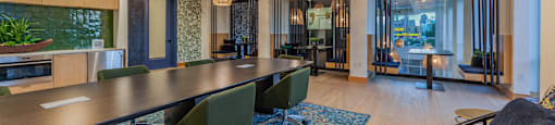 a room with a long table and chairs