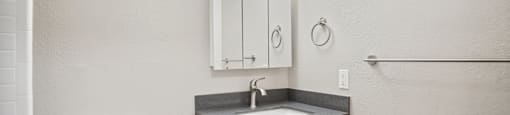 a white bathroom with a sink and a toilet
