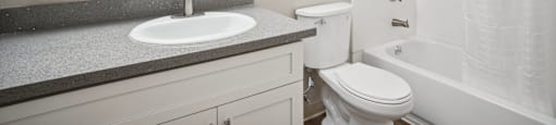 Fremont, CA Studios for Rent - Lincoln Glen - An interior shot of the bathroom, featuring a toilet, sink, and combination tub/shower