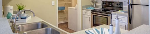 Modern kitchen with stainless steel appliances at Grande Club apartments in Duluth, GA 30096, near Lawrenceville.