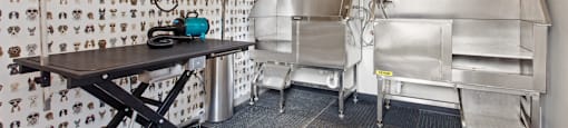 A room with a table and chairs and a wallpapered wall.