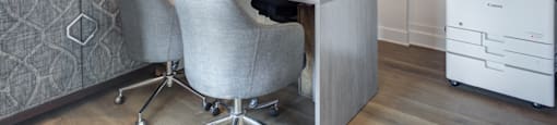 a home office with a desk and two chairs