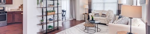 a living room with hardwood floors and white walls