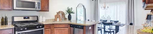 a kitchen with wooden cabinets and stainless steel appliances