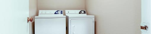 a washer and dryer in a laundry room with a door