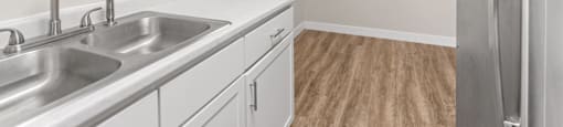 A kitchen with white cabinets and a stainless steel refrigerator.