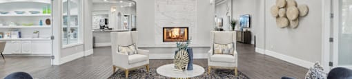 A living room with a fireplace and a chandelier.