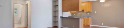 Dog Friendly Apartments in San Jose CA - Village of Taxco - Spacious Living Room with Wood-Style Flooring and Built-In Shelving.