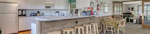 clubhouse kitchen with barstool and table seating