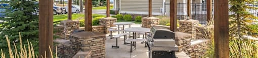 Apartments for Rent in Spokane WA - Deer Creek - BBQ Area with Grill, Seating Area, and Wooden Built-in Gazeebo