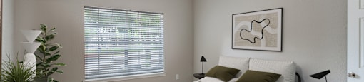 Bedroom with ceiling fan and plush carpeting at Sagewood at Westchase apartments in Houston, Texas.