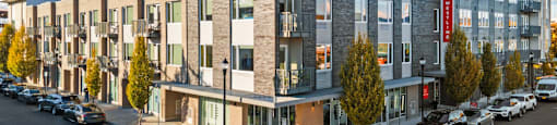 A modern building with a parking lot in front of it.