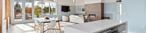 A modern kitchen with a dining table and chairs.