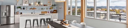 A modern kitchen with a dining table and chairs.