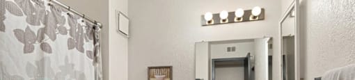 a bathroom with a shower and a toilet and a sink