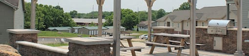 a pergola and picnic table on a patio