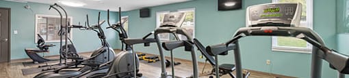 a gym with cardio equipment and exercise machines