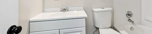 a bathroom with a sink toilet and a mirror