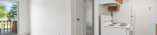 a white kitchen with a white stove and a refrigerator