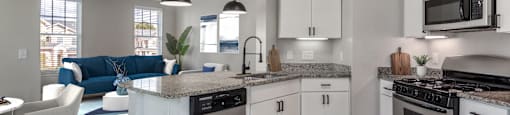 A modern kitchen with a large island and stainless steel appliances.