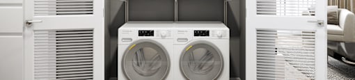 a white laundry room with a washer and a dryer