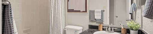 a white bathroom with a white toilet and a sink