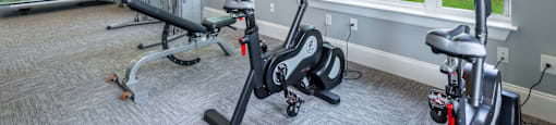 A gym with treadmills, elliptical machines, and stationary bikes.
