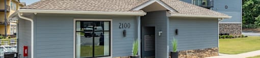 a blue house with a sidewalk in front of it