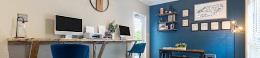 a home office with a computer desk and a couch