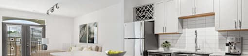 A modern kitchen with a large island and wooden floors.