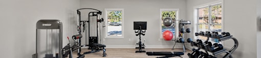 A spacious home gym with a variety of exercise equipment.