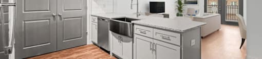 A modern kitchen with wooden floors and stainless steel appliances.