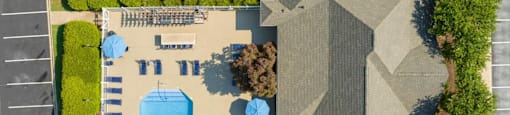 arial view of a house with a swimming pool and lawn